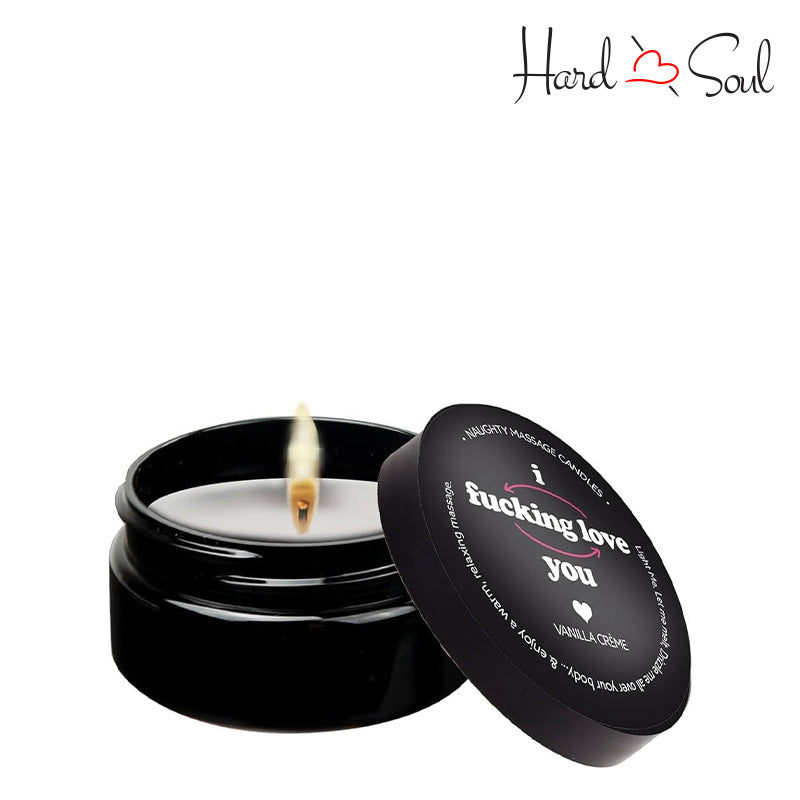 Black jar of a Naughty Massage Candle I F*cking Love You 1.7oz with the lid partially off, showing the candle lit inside - HardnSoul