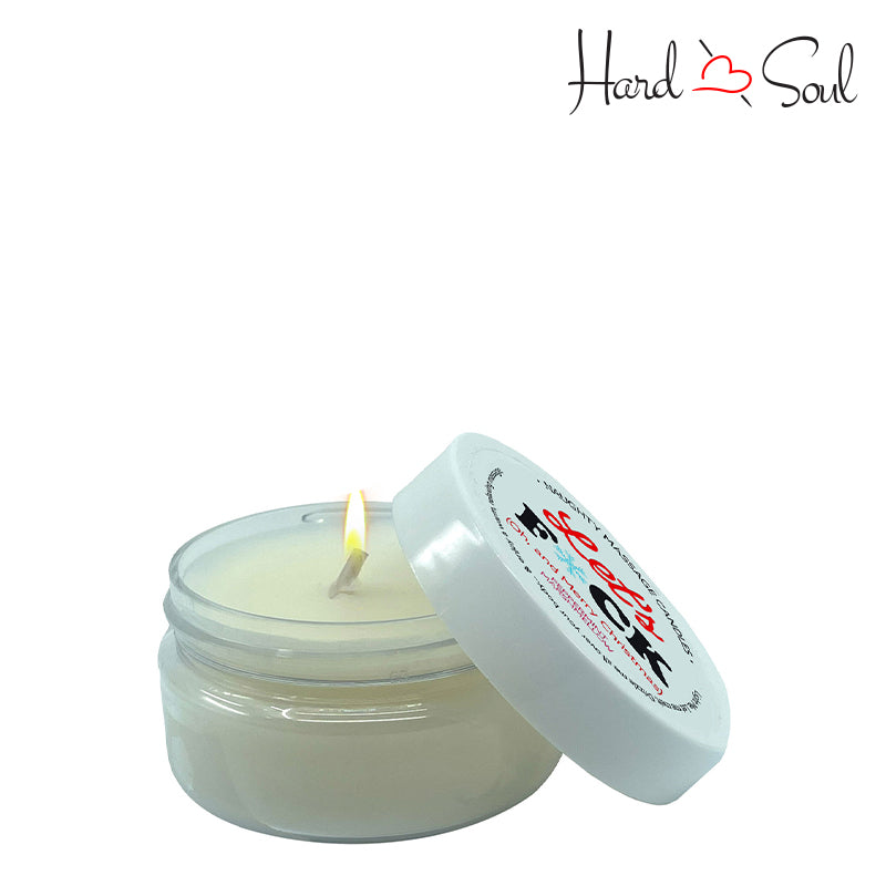 White Jar of Naughty Massage Candle Let's F*ck 1.7oz with the lid partially off, showing the candle lit inside - HardnSoul