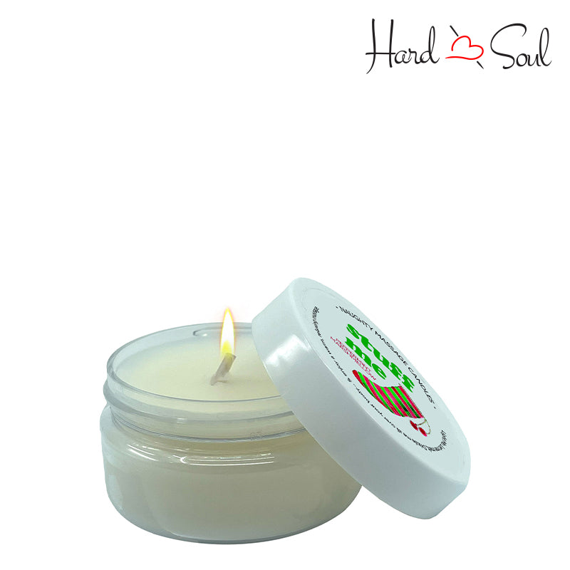 White Jar of Naughty Massage Candle Stuff Me 1.7oz with the lid partially off, showing the candle lit inside - HardnSoul