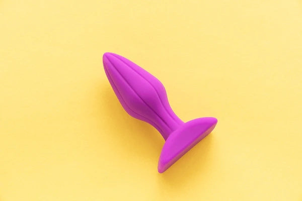 Pink Anal Toy on a yellow background