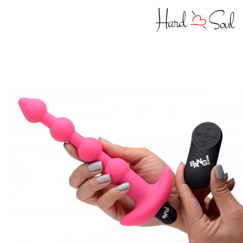 A Bang Remote Control Vibrating Silicone Anal Beads Pink in hand - HardnSoul