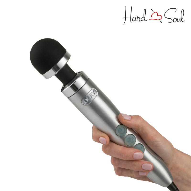 In hand of Doxy Die Cast 3 Wand Massager Brushed Metal with adjustment buttons - HardnSoul
