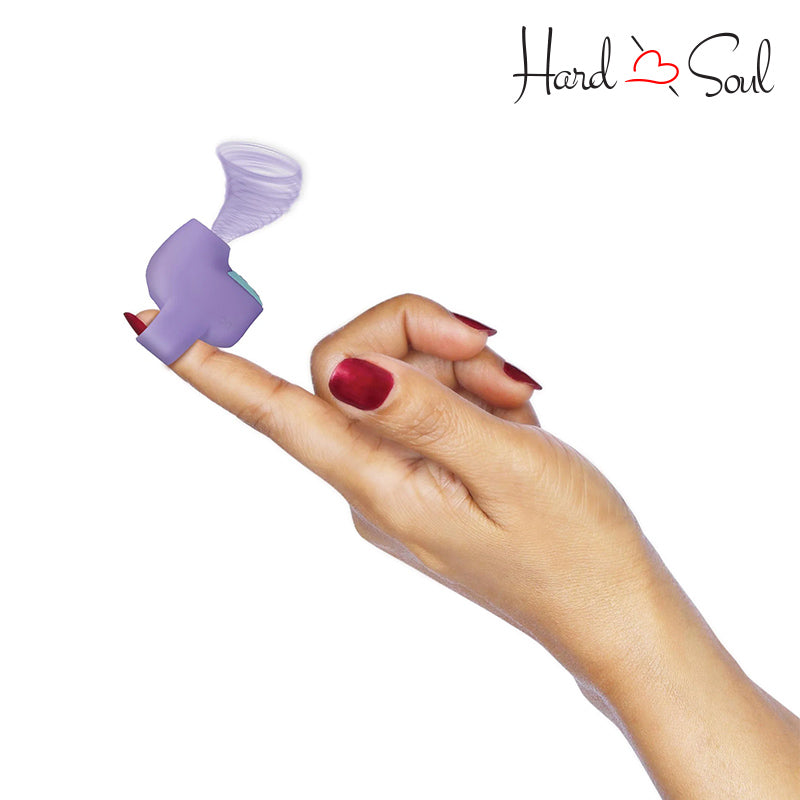 A Inmi Shegasm Mini Clitoral Stimulator Purple in hand - HardnSoul