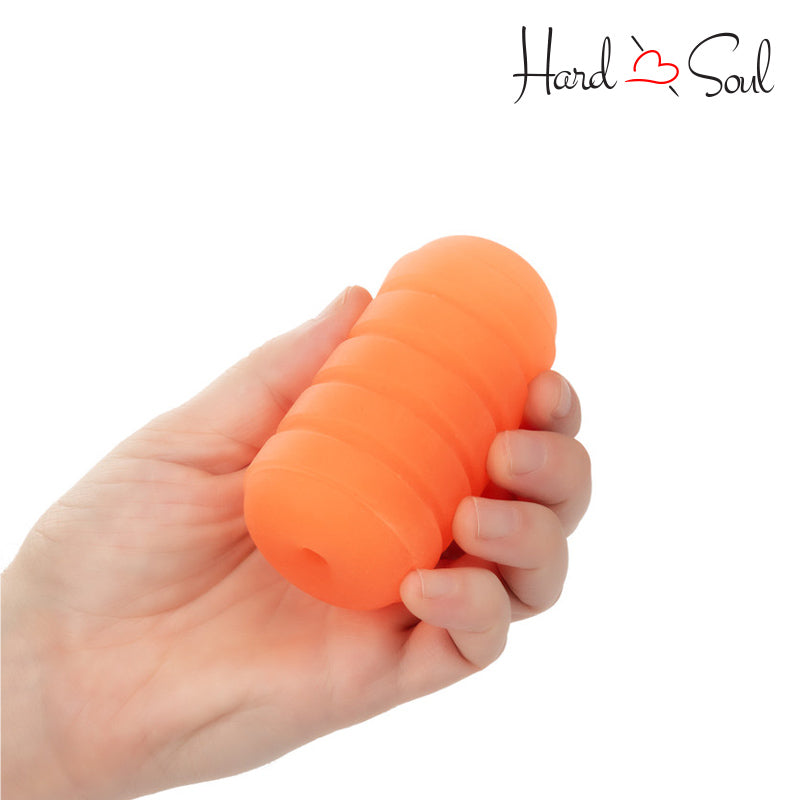 A Pop Sock Ribbed Stroker Orange in hand - HardnSoul