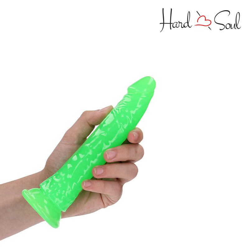 RealRock Glow in the Dark 7 Inch Slim Dildo Green in a hand - HardnSoul